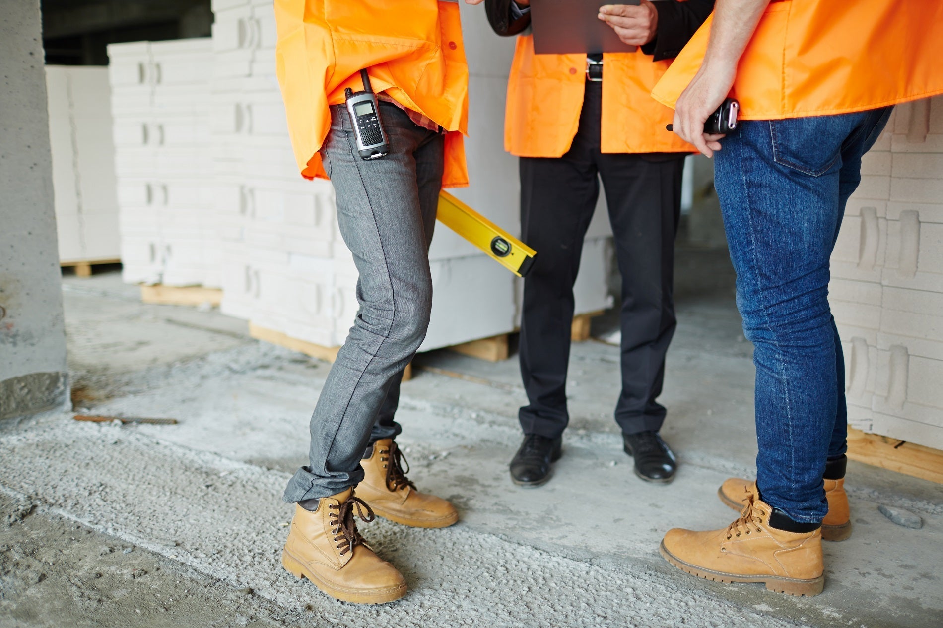 Construction workers having a safety meeting while wearing safety boots and shoes sold by Boot World