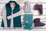 Winter clothing laid out including pair of Ugg boots sold by Boot World